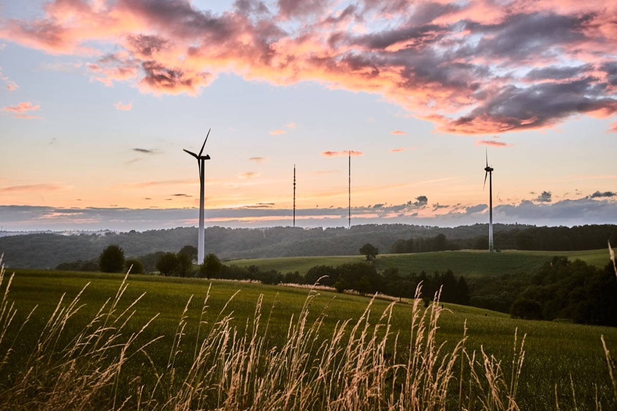 Wind turbines on a hillside at dusk